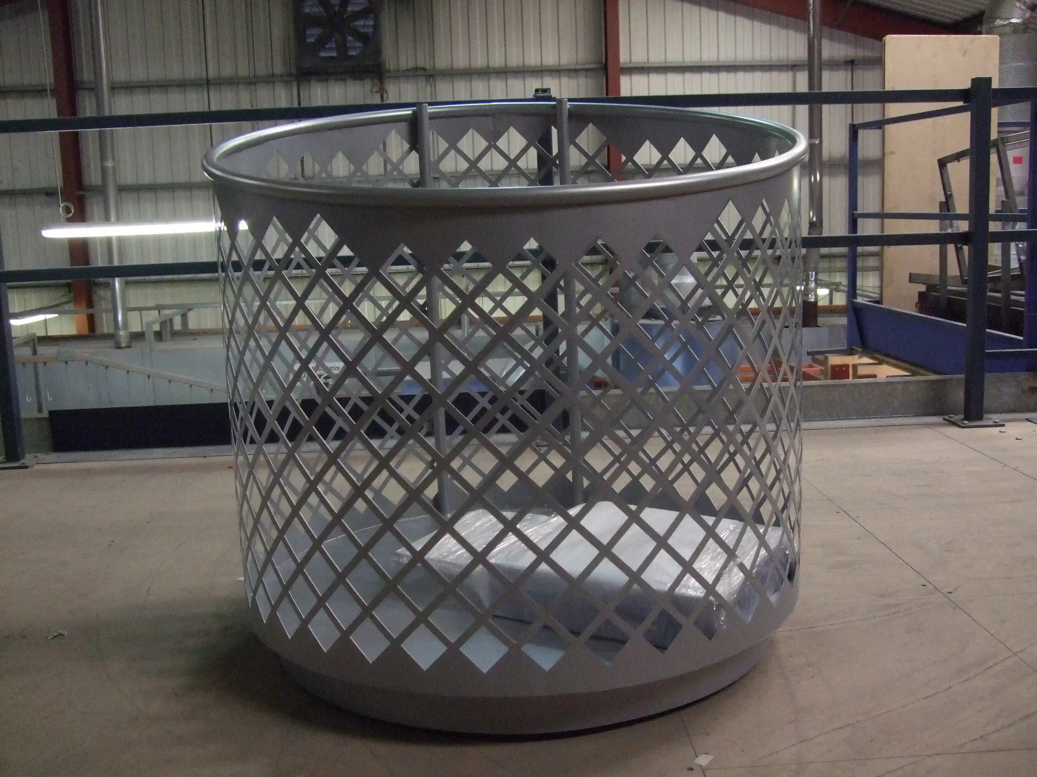 Circular Perforated Metal Retail Dump Bin manufactured by Techrail Round merchandise display bin fabricated from perforated steel with a reinforced top rim and base.