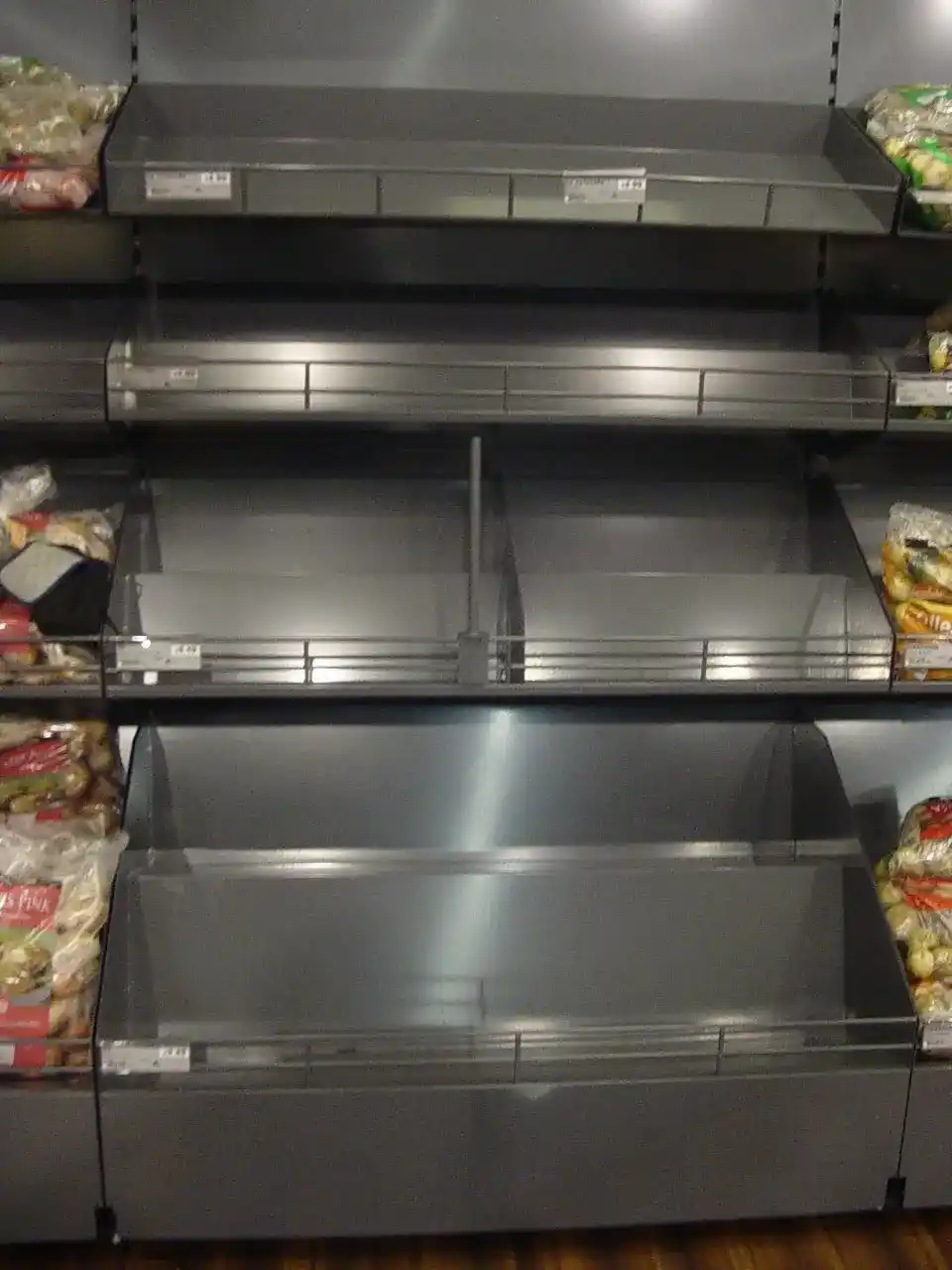 Multi-Tier Metal Retail Display Shelving manufactured by Techrail Powder-coated merchandising unit with multiple angled steel display shelves.