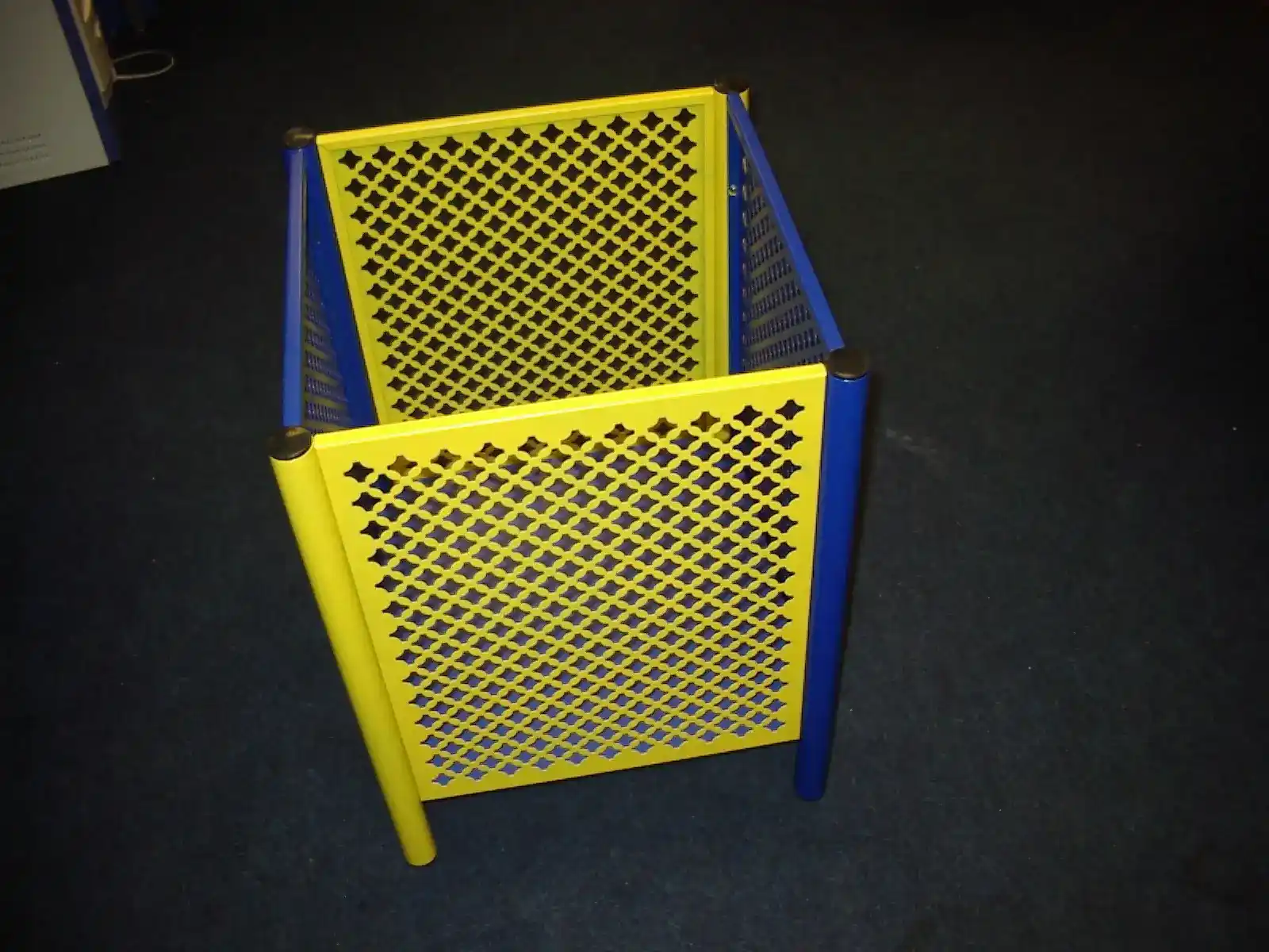 Perforated Metal Retail Dump Bin manufactured by Techrail Bright powder-coated merchandise bin manufactured from perforated steel panels and tubular frames.