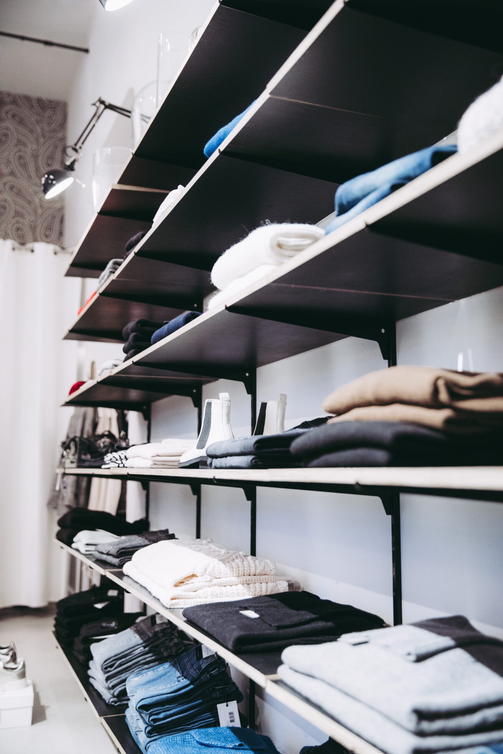 Wall-Mounted Metal Retail Shelving manufactured by Techrail Retail display shelving supported by fabricated metal wall brackets.